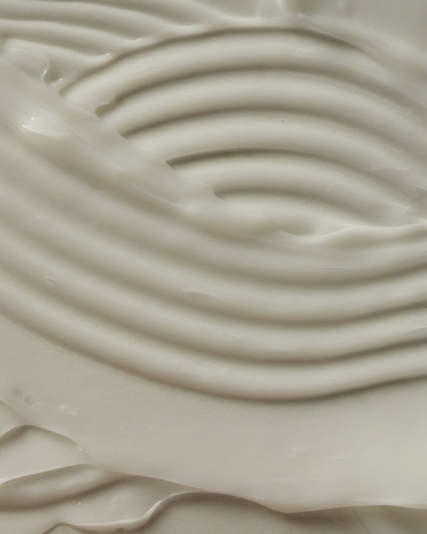 Macro close-up of a creamy Aveda hair product swirled into concentric ridges, social video still produced by The Charles Group