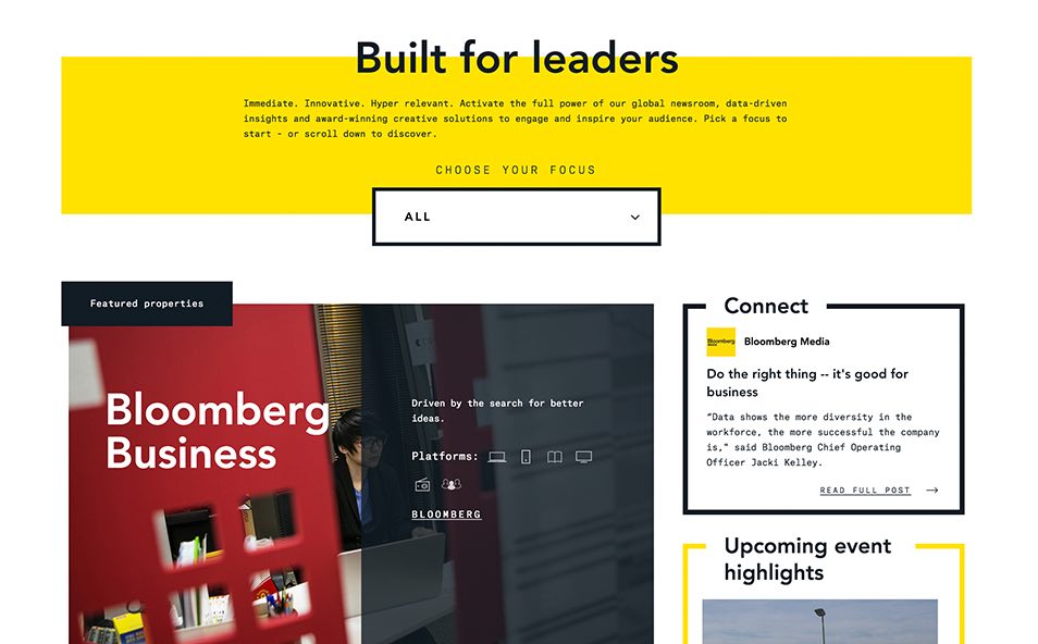 Bloomberg Media website homepage section showing bold dark editorial hero layout with large feature typography, designed by The Charles Group