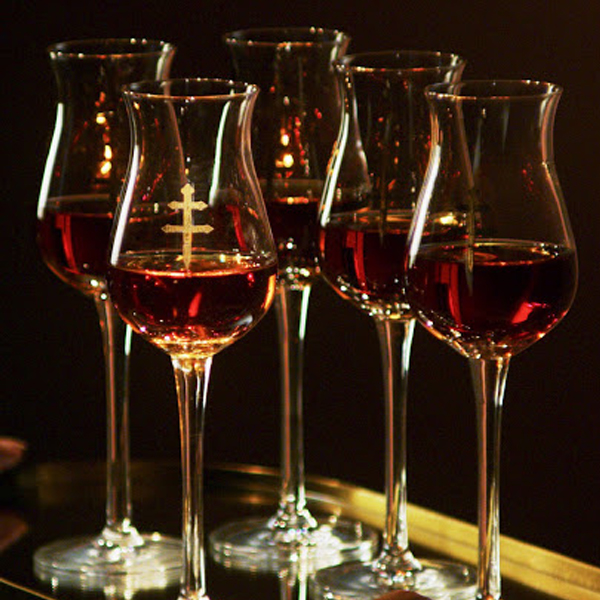Six D'ussé branded cognac glasses filled and arranged on a gold tray, shot for the D'ussé Holiday social campaign by The Charles Group