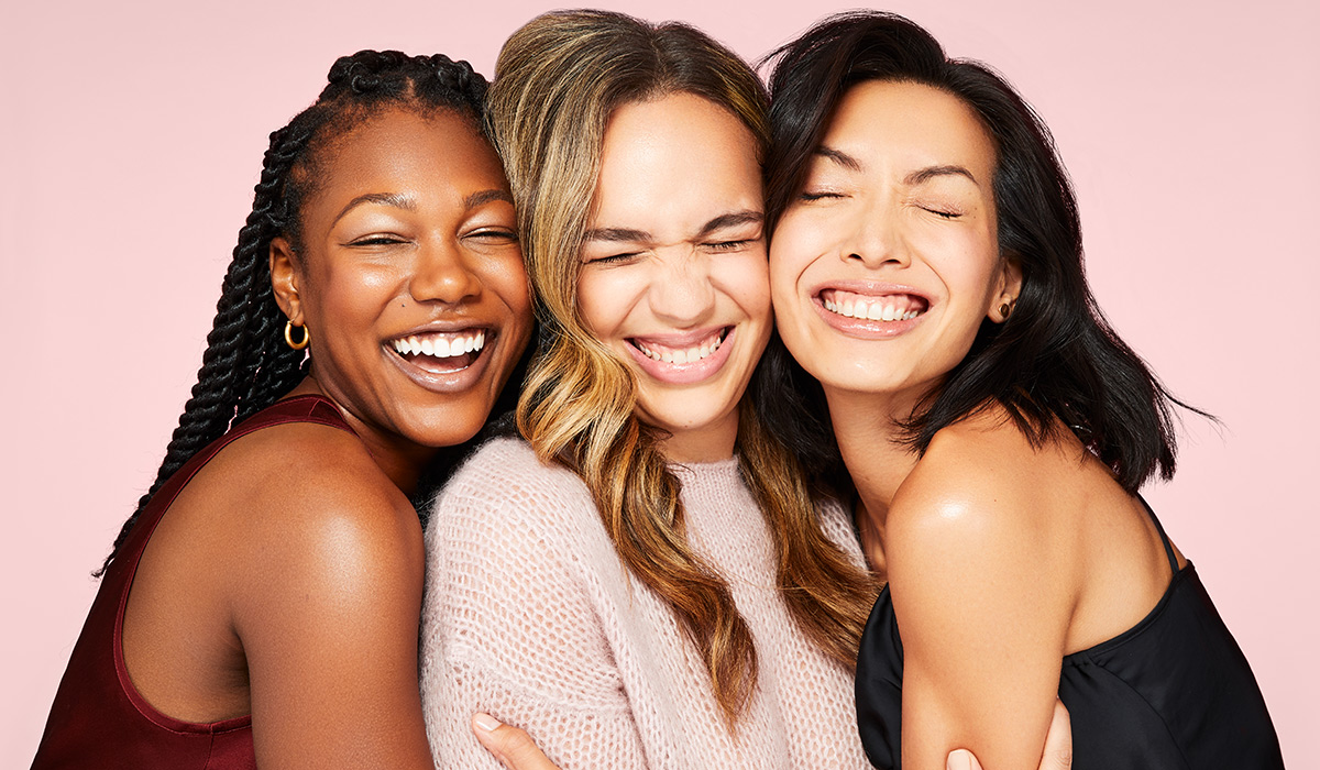 Three diverse models laughing together in Erno Laszlo holiday campaign