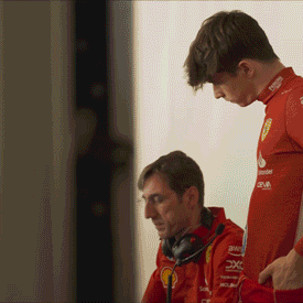 Ferrari engineers reviewing HP analytics data in the pit lane