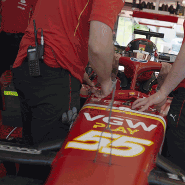 Ferrari pit crew working on an F1 car during race day