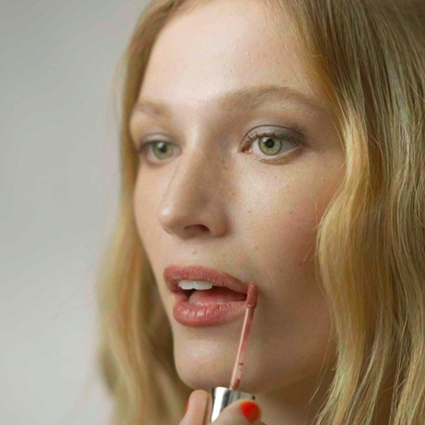 Kjaer Weis social content video frame showing organic beauty product application, produced by The Charles Group