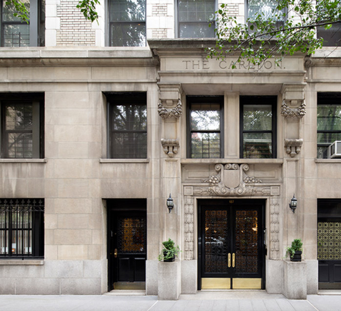 Ornate stone facade of The Carlton building, a KLM Equities residential property in New York City
