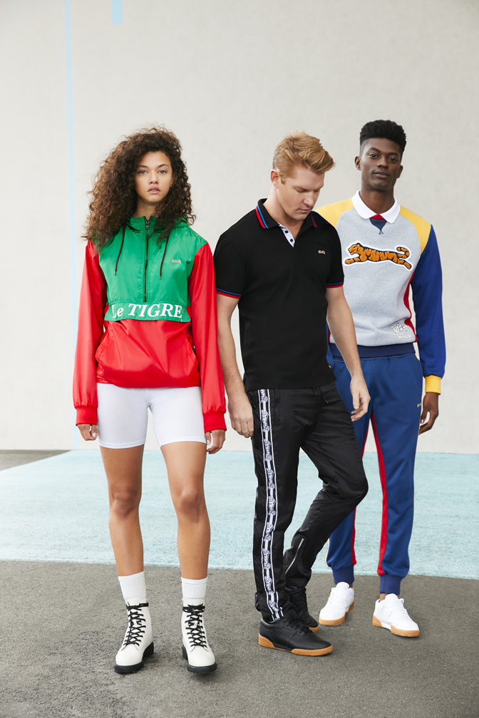 Male model in Le Tigre striped polo, confident pose in retro sportswear campaign by The Charles Group