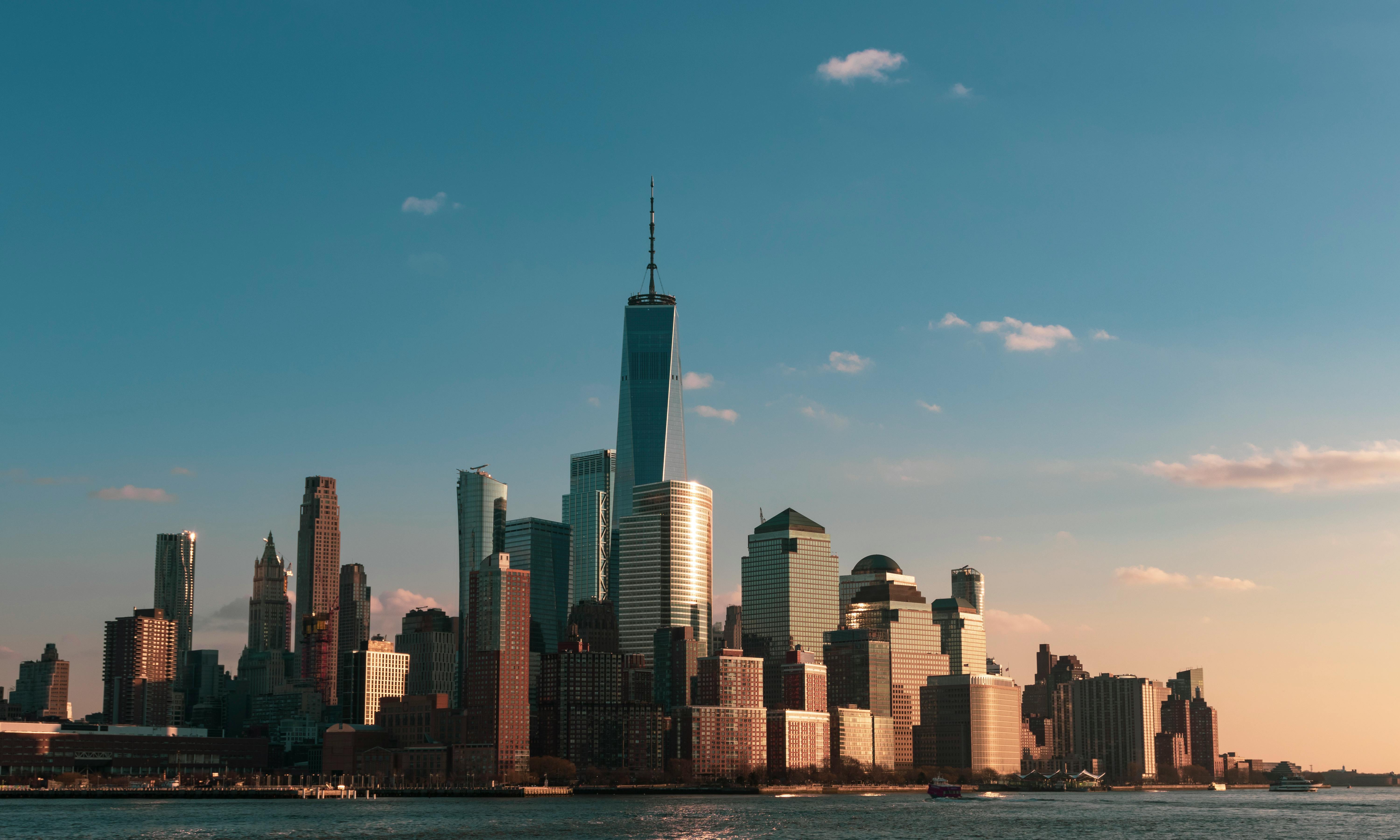 Lower Manhattan skyline at golden hour, reflecting The Charles Group's luxury real estate marketing work for Corcoran in New York