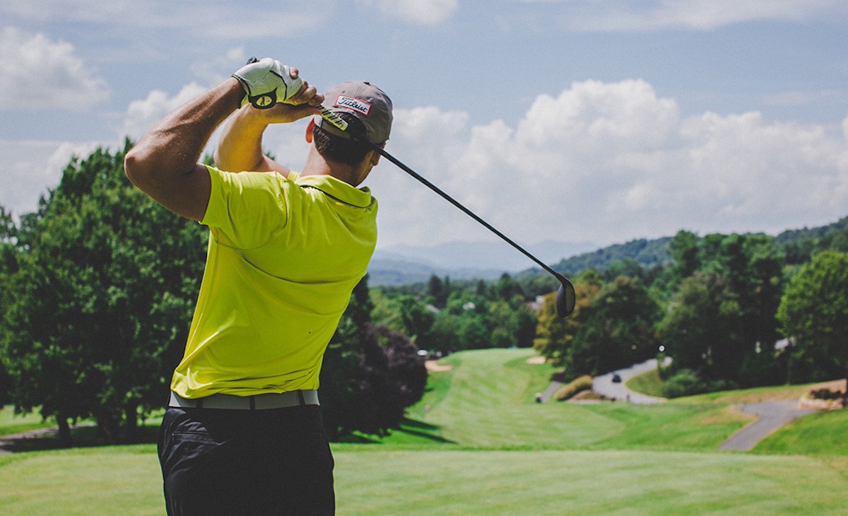 Golfer mid-swing on a lush fairway, hero image for The Charles Group's Microsoft Transforming the Course campaign