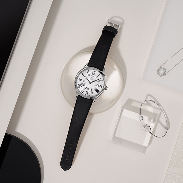 Omega Constellation luxury watch close-up on dark background, product photography by The Charles Group