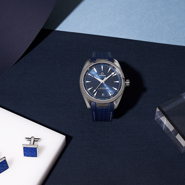 Woman at a vanity getting ready wearing an Omega watch, lifestyle content by The Charles Group