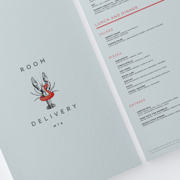 Showfish branded to-go packaging and tissue paper flat-lay showing restaurant identity system by The Charles Group