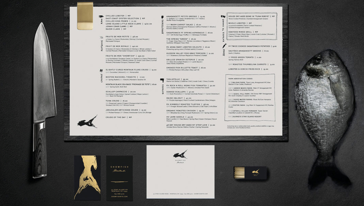 Multiple Showfish menus fanned out showing logo and textured paper stock, brand collateral by The Charles Group