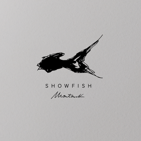 Flat-lay of Showfish printed menu collateral showing brand typography and layout, designed by The Charles Group