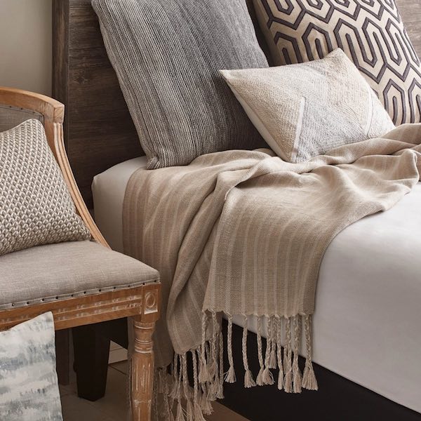 Threaded Home linen throw and mixed pillow bedroom styling, produced for paid and organic social content by The Charles Group