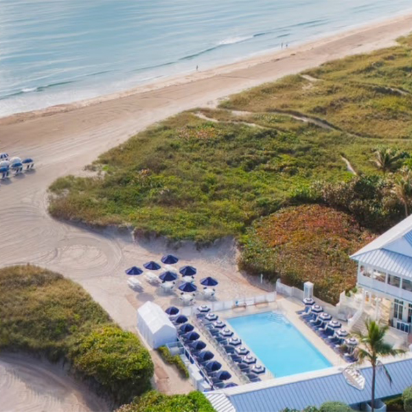 Aerial view of a Turnberry oceanfront resort pool and beach club in Florida, marketed by The Charles Group