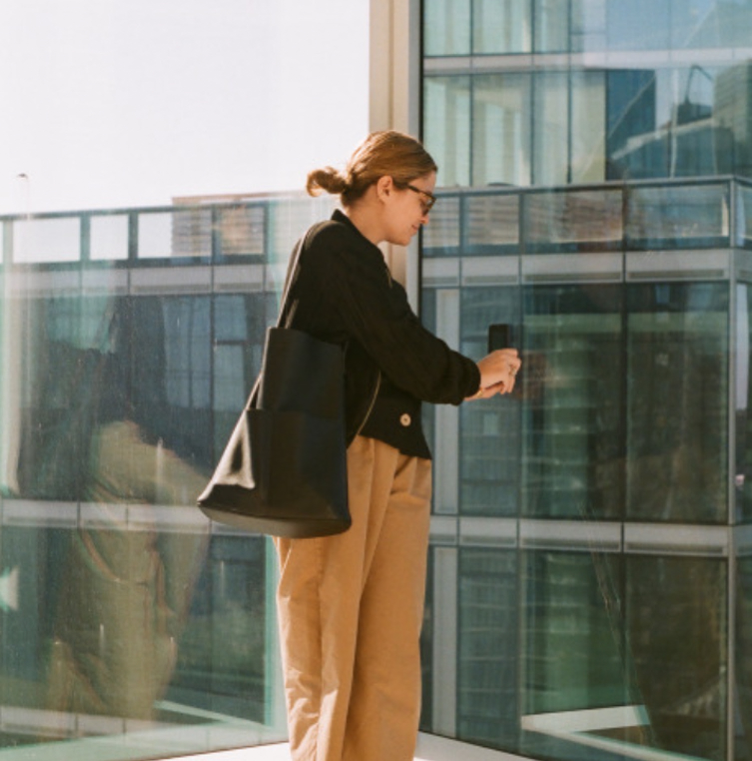 A creative agency employee arriving at a glass office building