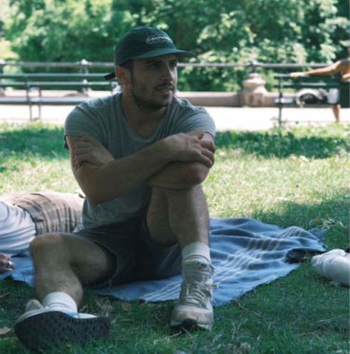 A creative agency team member relaxing on the grass during a team day out