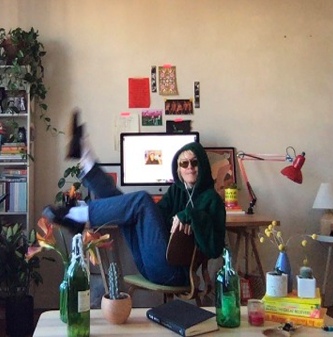 A creative agency employee working from a colorful, plant-filled home office