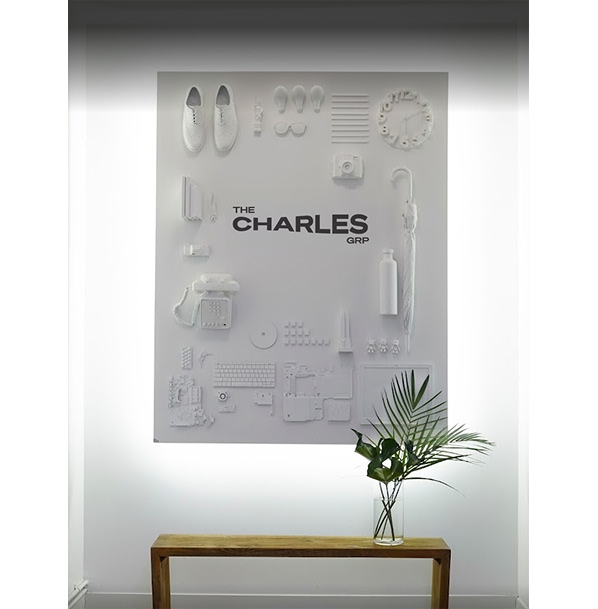 The Charles Group branded wall art display in office lobby
