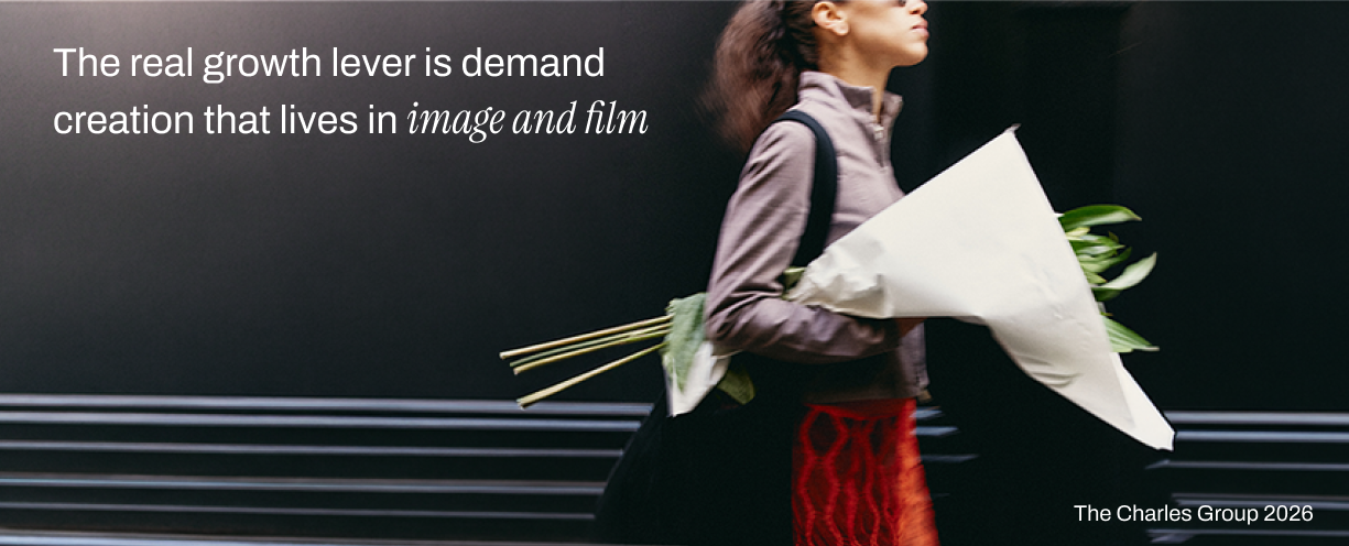 Motion-blurred street photograph of a woman carrying wrapped flowers, illustrating image and film as the core tools of luxury brand demand creation